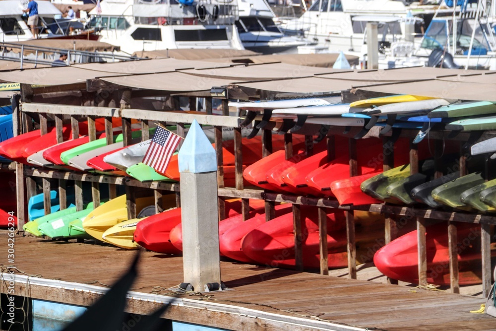 Colorful watercraft rentals waiting to be used on the water