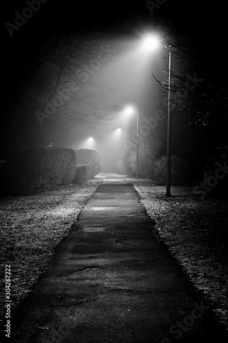 Dimly lit dark pathway at night.