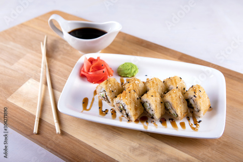 Japanese food rolls in white plate with soy sauce