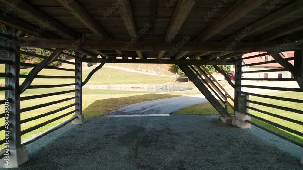 Drone forward moving through barn in countryside with lake Drone forward moving through barn in countryside with lake
