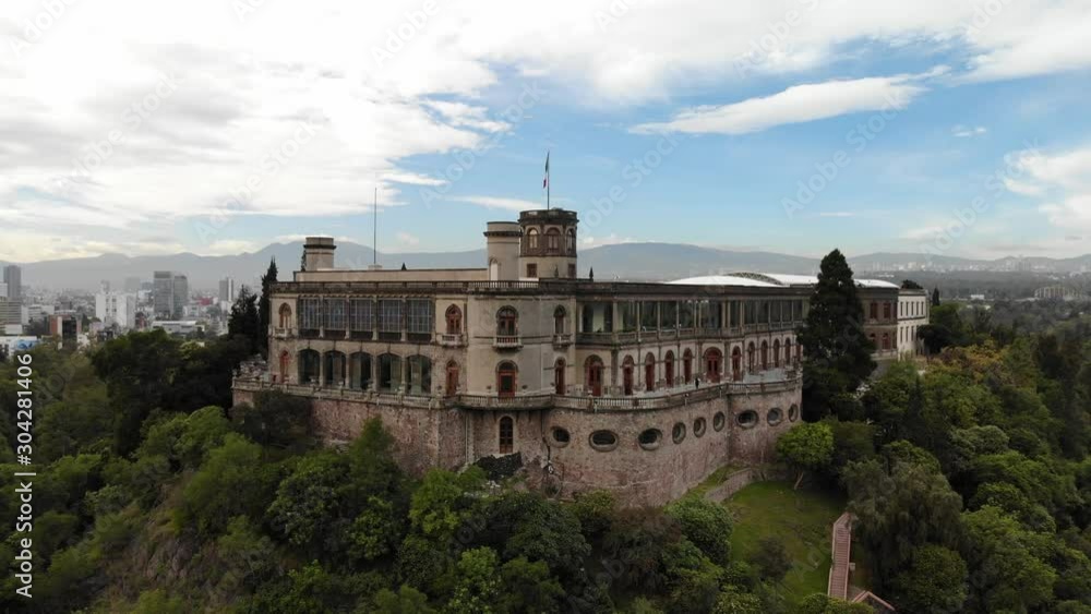 Revealing Mexico City skyline behind the Chapultepec Castle at sunrise, drone slowly ascending Revealing Mexico City skyline behind the Chapultepec Castle at sunrise, drone slowly ascending