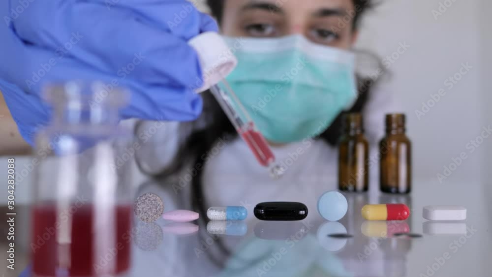 Researcher examine white pills in laboratory. Pharmacy industry developing new medicament. Researcher examine white pills in laboratory. Pharmacy industry developing new medicament.