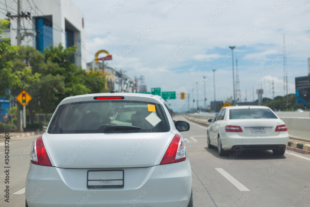 car on road traffic jam with blank sign sticker on back for design your text