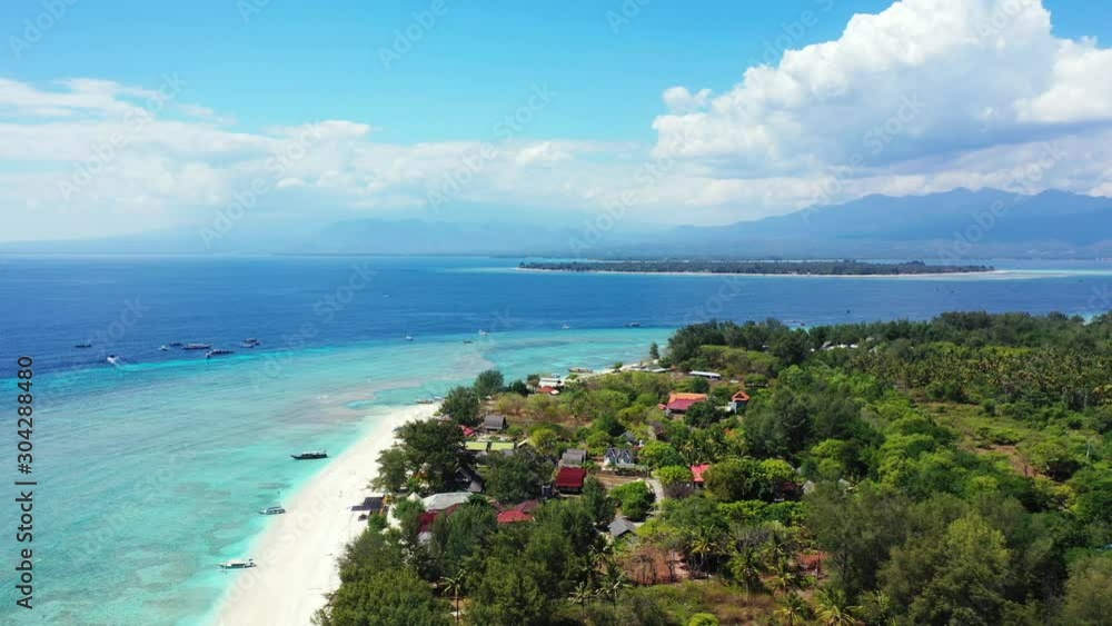 Bright sky with big white clouds over tropical island with lush vegetation and touristic villages surrounded by blue turquoise sea water in Thailand Bright sky with big white clouds over tropical island with lush vegetation and touristic villages surrounded by blue turquoise sea water in Thailand