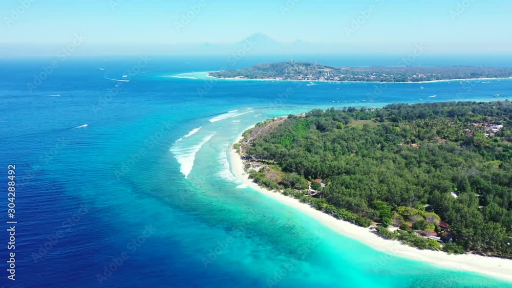 Blue azure sea around tropical islands with trees forest and a lot of agricultural plantations, washed by white waves on a misty sky on morning in Bali Blue azure sea around tropical islands with trees forest and a lot of agricultural plantations, washed by white waves on a misty sky on morning in Bali