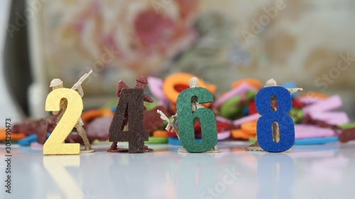 Fotografie Image of even numbers with toy soldiers at background