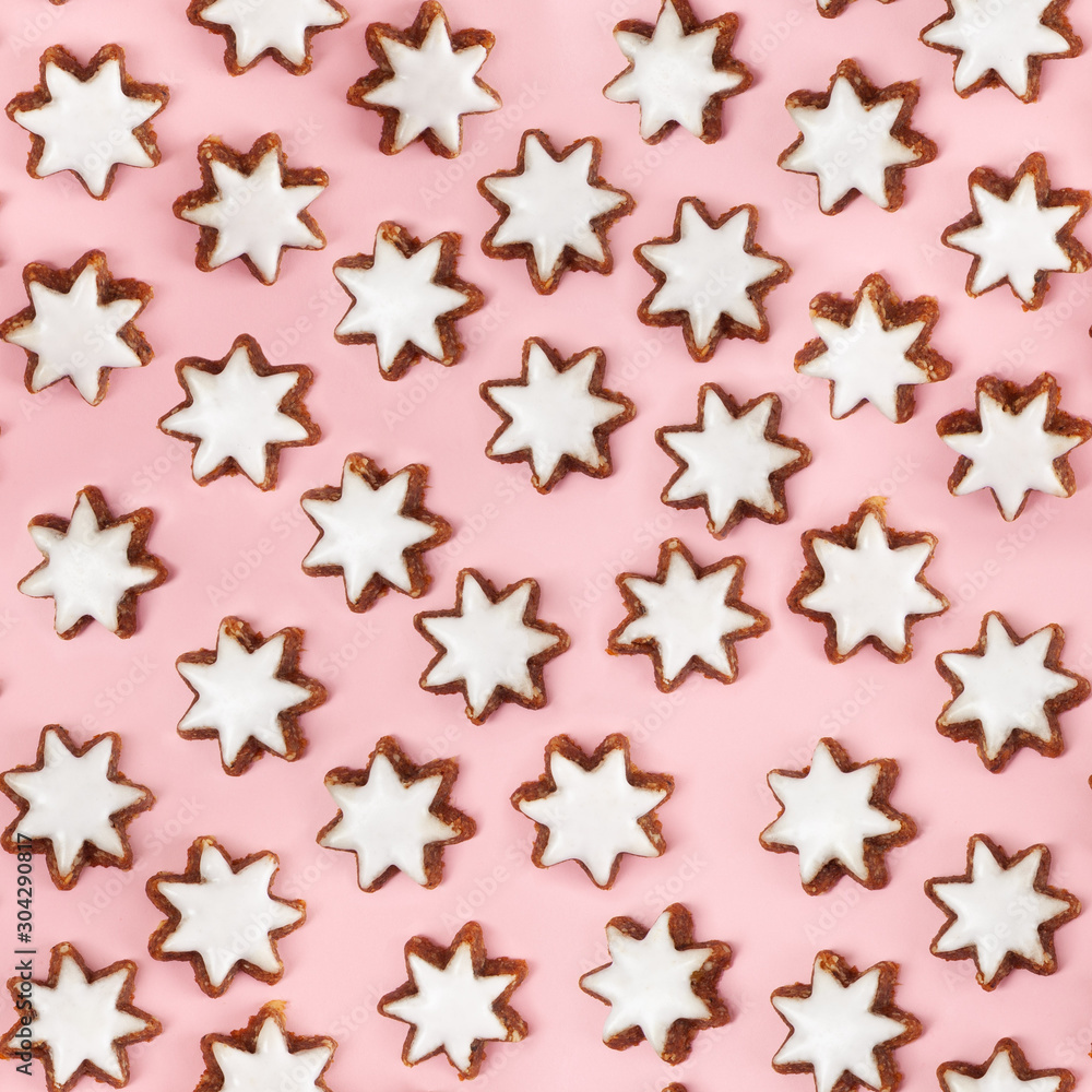 Almond stars biscuits with sugar icing on pink background - seamless pattern Almond stars biscuits with sugar icing on pink background - seamless pattern