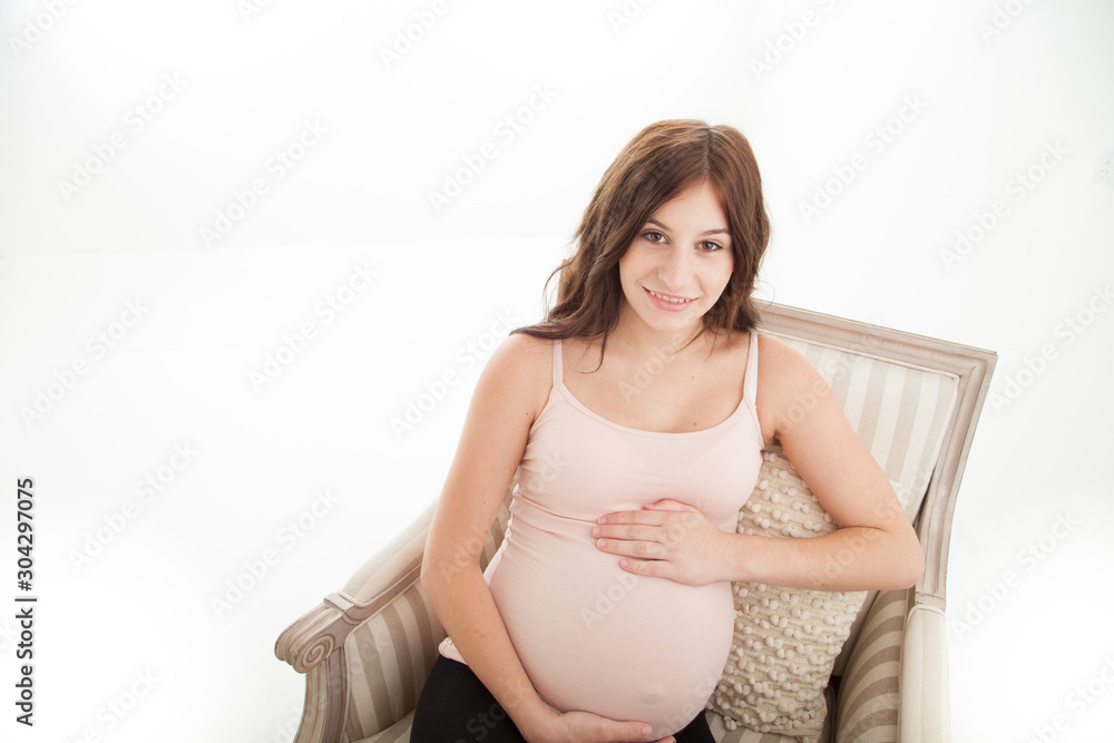 Smiling pregnant female on white background with negative copy space Smiling pregnant female on white background with negative copy space