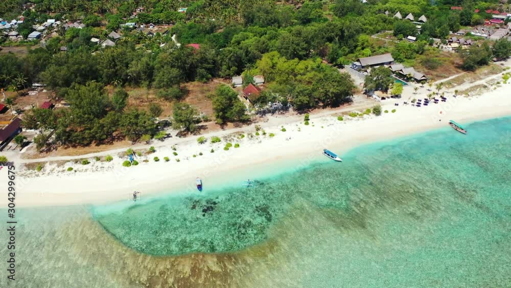 Flying Over Tropical Beach Island Coral Reef Turquoise Caribbean Sea, floating boats,palms and resorts Flying Over Tropical Beach Island Coral Reef Turquoise Caribbean Sea, floating boats,palms and resorts