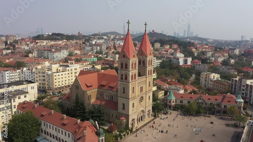 Wallpaper Mural Flying past towers and crosses of Saint Michael's Cathedral towards beautiful skyline of Qingdao, China Torontodigital.ca