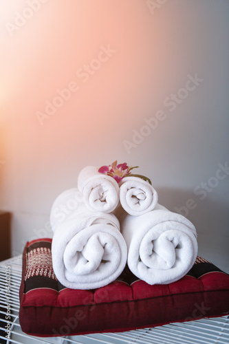 Towel with Orchid decoration in bedroom interior for hotel customer.