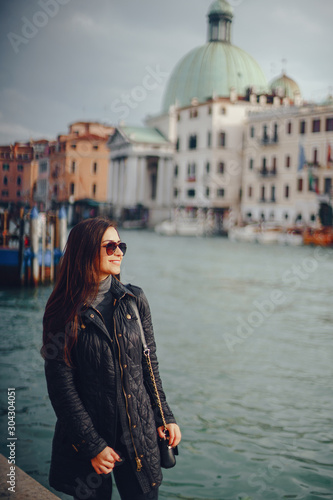 female tourist walking around and exploring venice in the early spring