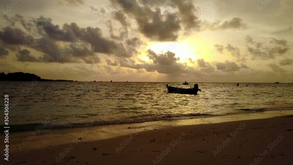 A Stunning Scene Of A Boat Anchored By The Shore Of The Fiji Islands In Twilight - Wide Shot A Stunning Scene Of A Boat Anchored By The Shore Of The Fiji Islands In Twilight - Wide Shot