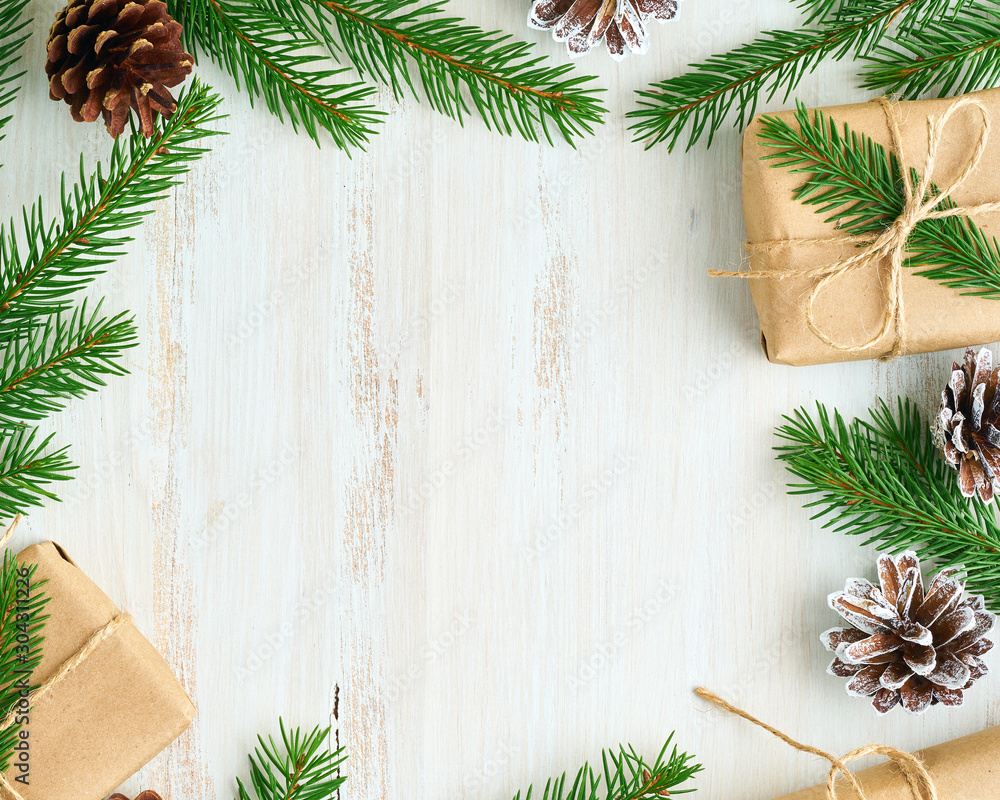 Christmas and Happy New Year zero waste wooden backdrop. Handmade gift Christmas box, fir branches, craft paper , top view, copy space. Ecofriendly plastic free concept - obrazy, fototapety, plakaty 