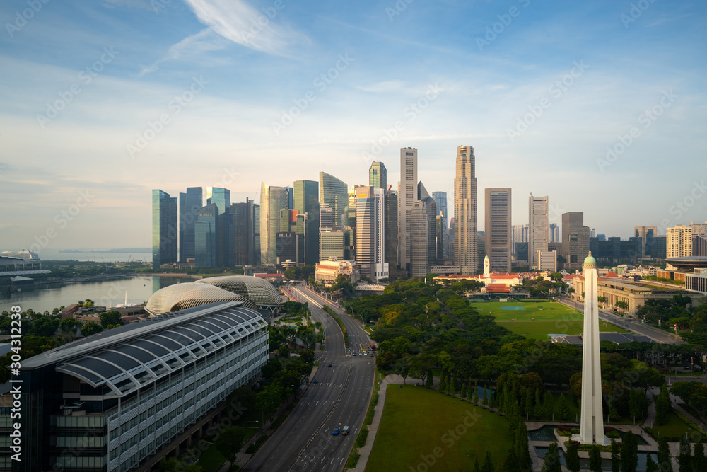 Panorama of Singapore business district skyline and skyscraper during sunrise at Marina Bay, Singapore. Asian tourism, modern city life, or business finance and economy concept.