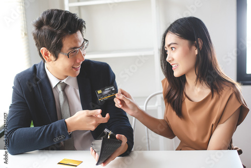 Fotografija Beautiful young woman introduced credit cards to employees in offices in order to be officially released for various financial problems