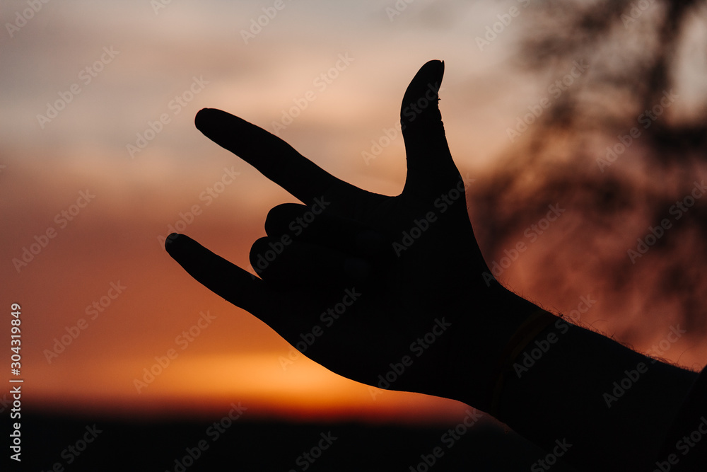 Silhouette of a hand of a person gesturing with his fingers