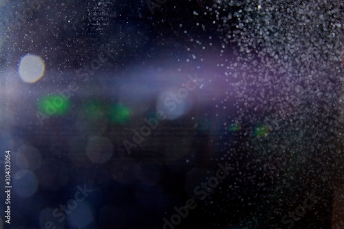 Abstract dust explosion and flash with illumination on a black background