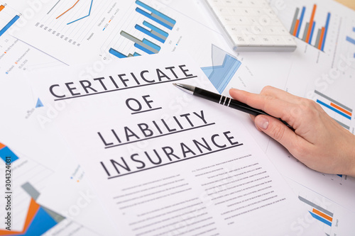 certificate of liability insurance concept, documents on the desktop