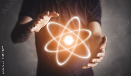 Konstfotografi Man holding atom. Energy. Science. Connection