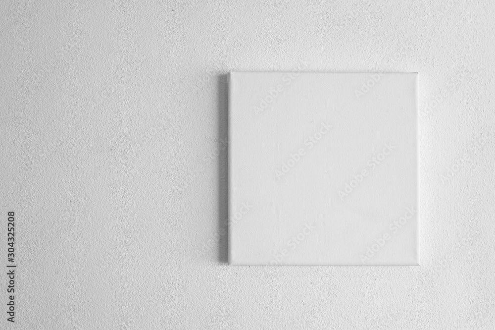 single  white rectangular canvas frame on cement wall background - obrazy, fototapety, plakaty 