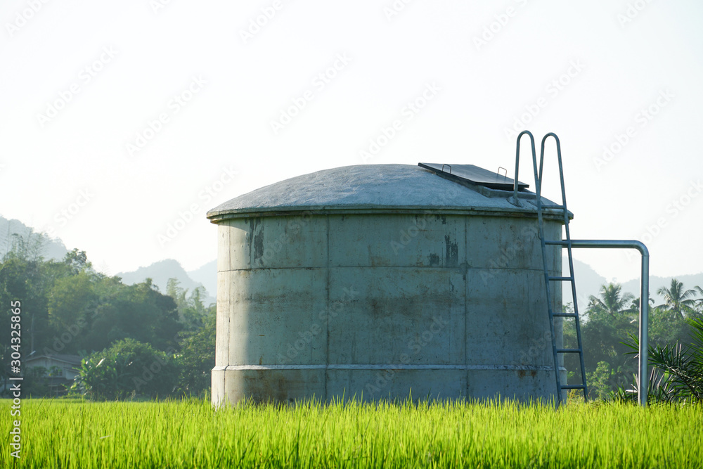 water tank in the field on rural property, oil tank, water irrigation method used by farmers in rural villages, System for pumping irrigation water for agriculture, Water supply pipeline, fuel cylind water tank in the field on rural property, oil tank, water irrigation method used by farmers in rural villages, System for pumping irrigation water for agriculture, Water supply pipeline, fuel cylind