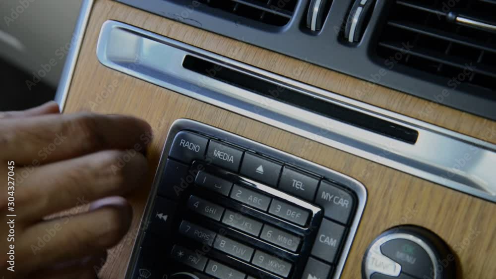 Close up hand of man turn up radio car volume Close up hand of man turn up radio car volume