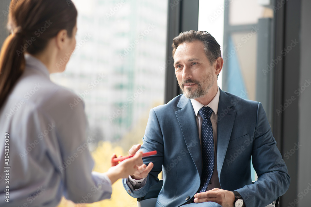 Affluent entrepreneur speaking with journalist while giving interview Affluent entrepreneur speaking with journalist while giving interview