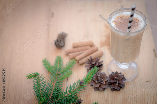 Chocolate Martini Cocktail or eggnog with cinnamon and chocolate in glass for Christmas on mahogany background. Homemade festive cocktail for winter holidays.Close up.