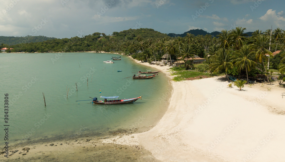 Aerila drone scene of sandy clean beach and fishing boats - Koh Samui - Thailand