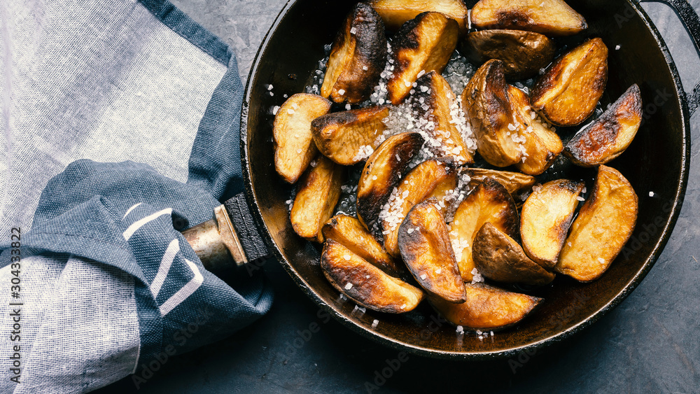 Fried potatoes in a cast-iron skillet. Macro shot. Fried potatoes in a cast-iron skillet. Macro shot.