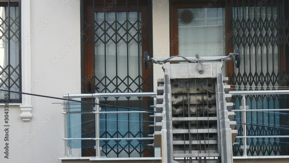 Moving house elevator on outside of apartment during moving house activity. Moving house elevator on outside of apartment during moving house activity.