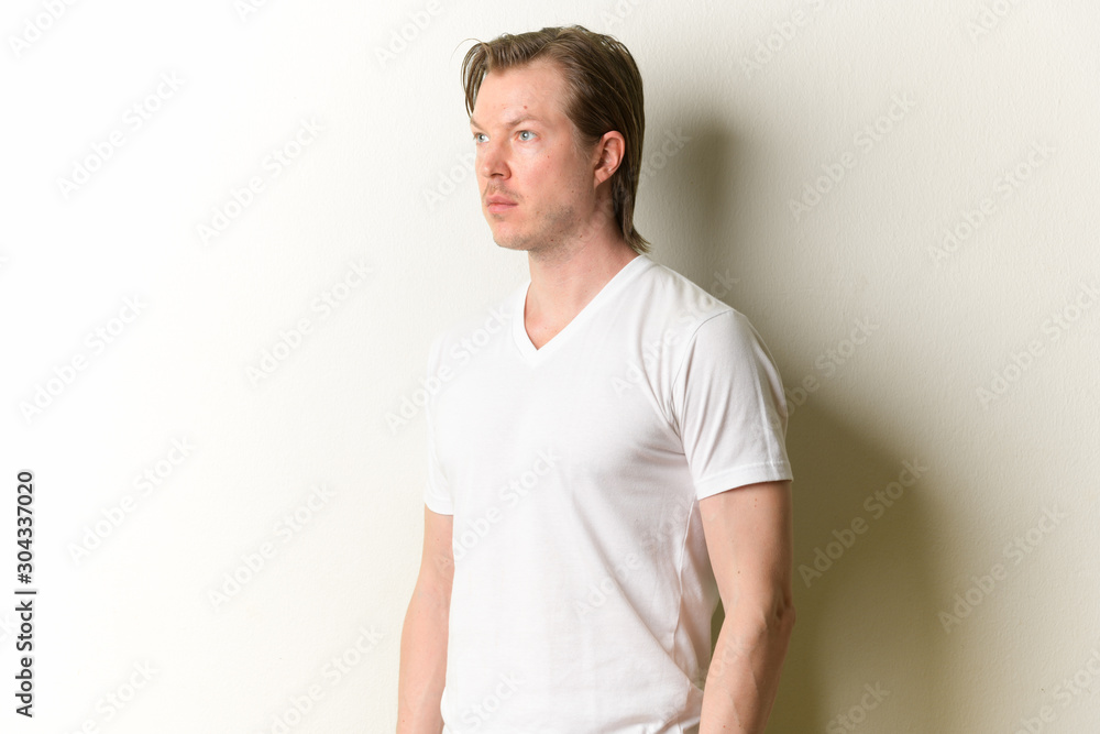 Portrait of young handsome man thinking and looking away Portrait of young handsome man thinking and looking away