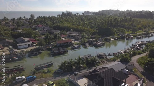 Aerial view of fisherman village with boats dock at the river estuary nearby. photo