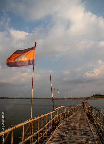 cambodian flag on old traditional bamboo wooden bridge across Mekong river (from Koh Paen island to Kampong Cham), Cambodia