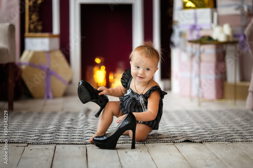 Little toddler daughter and mother's black shoes