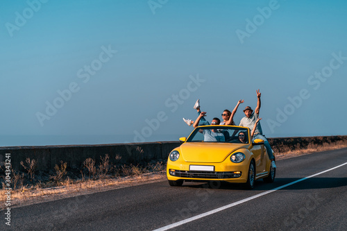 The friends travel by a cabriolet