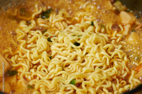 Cooking instant ramen noodle in pot 