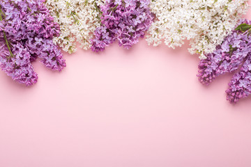 Branches of lilac on pink background. White and purple lilac. Romantic spring mood. Top view. Copy for your text - Image