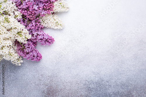 Branches of purple lilac on stone background. Romantic spring mood. Top view. Copy for your text. Horizontal banner - Image