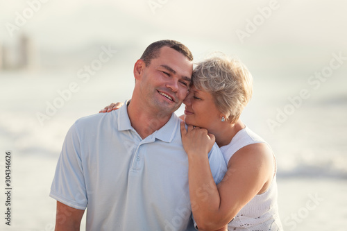 Portrait of a happy lovers husband and wife. Couple walks along the sea at sunrise