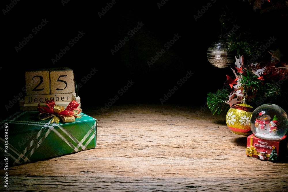 Empty wooden table with gift box and lights on Christmas Day on wooden table.