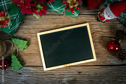 Top view, empty chalkboard Decoration with gift box and lights on Christmas Day on wooden table.aerial view