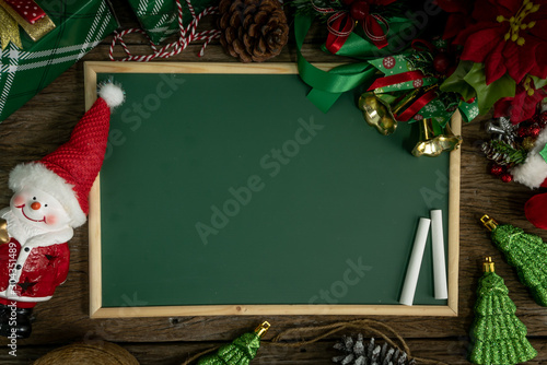 Top view, empty chalkboard Decoration with gift box and lights on Christmas Day on wooden table.aerial view