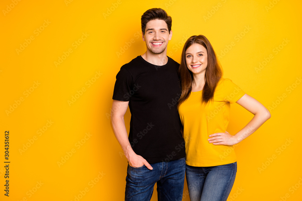 Photo of cheerful positive nice cute pretty couple hugging with man holding hand in jeans denim pocket smiling toothily isolated over vivid color background - obrazy, fototapety, plakaty 