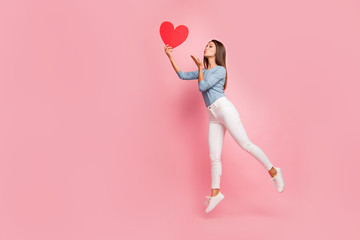 Full length body size side brown haired profile photo of cheerful positive cute pretty nice tender girl sending air kiss to heart held isolated pastel color background