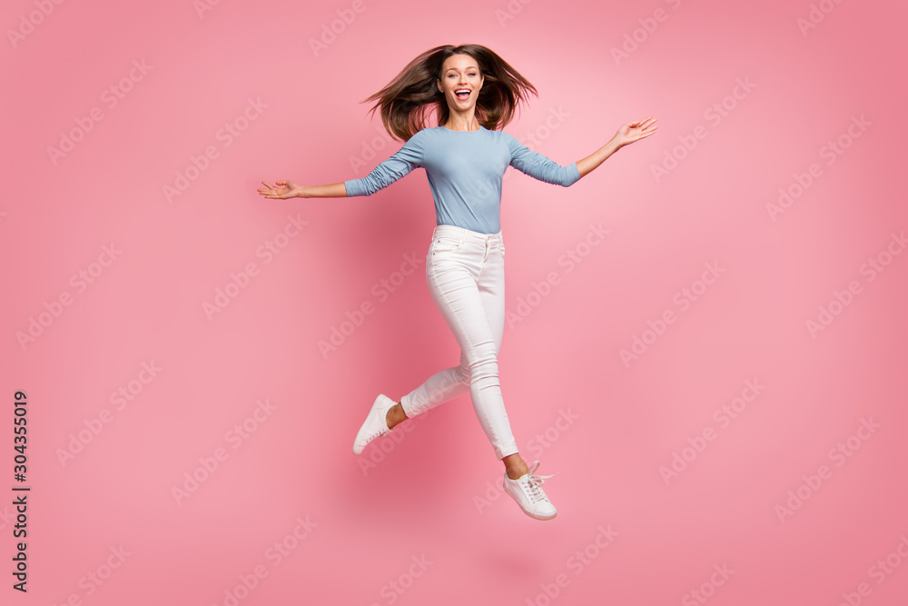Turned full length body size photo of cheerful positive pretty sweet girl feeling freedom running jumping isolated pastel color background