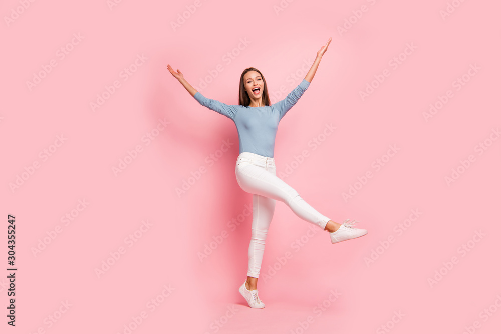Fototapeta premium Turned full length body size photo of pretty sweet cute charming woman throwing her leg with hands up screaming rejoicing in having rest isolated pastel color background
