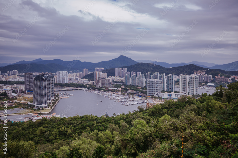 Top View of Hainan's Sanya City, with local houses and luxury hotels and buildings. Summer Vacation Paradise in Asia.