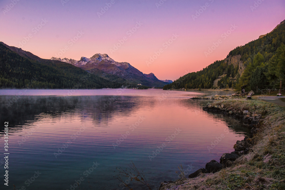 Mountain lake panorama with mountains reflection. Idyllic look. Autumn forest. Silvaplana Lake, Switzerland